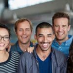 Positive work environment. Shot of a smiling group of coworkers standing in an office.