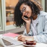 Young successful african-american businesswoman student working on laptop remotely