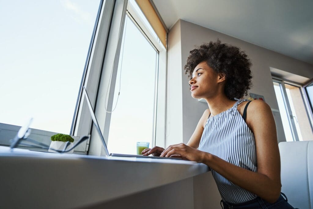 Cute remote worker daydreaming in the workplace