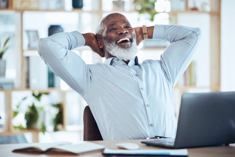 Happy black man stretching at desk for relax, online success and work life balance on office laptop