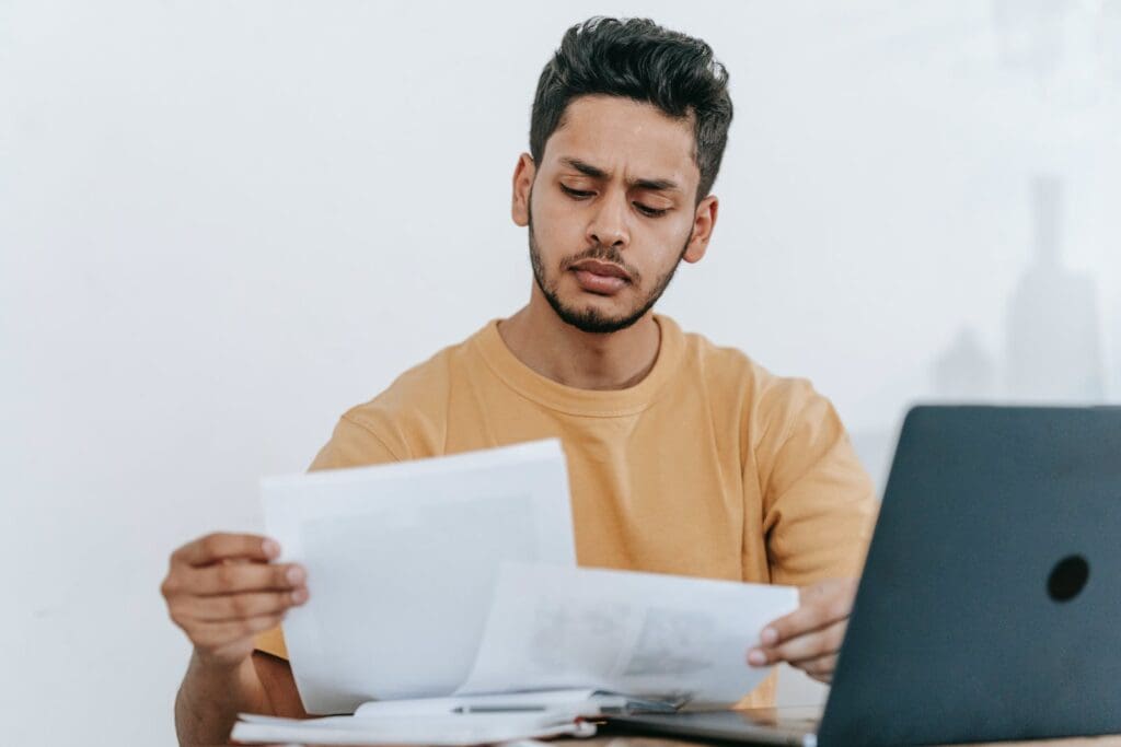 Professional critic looking through documents at workplace
