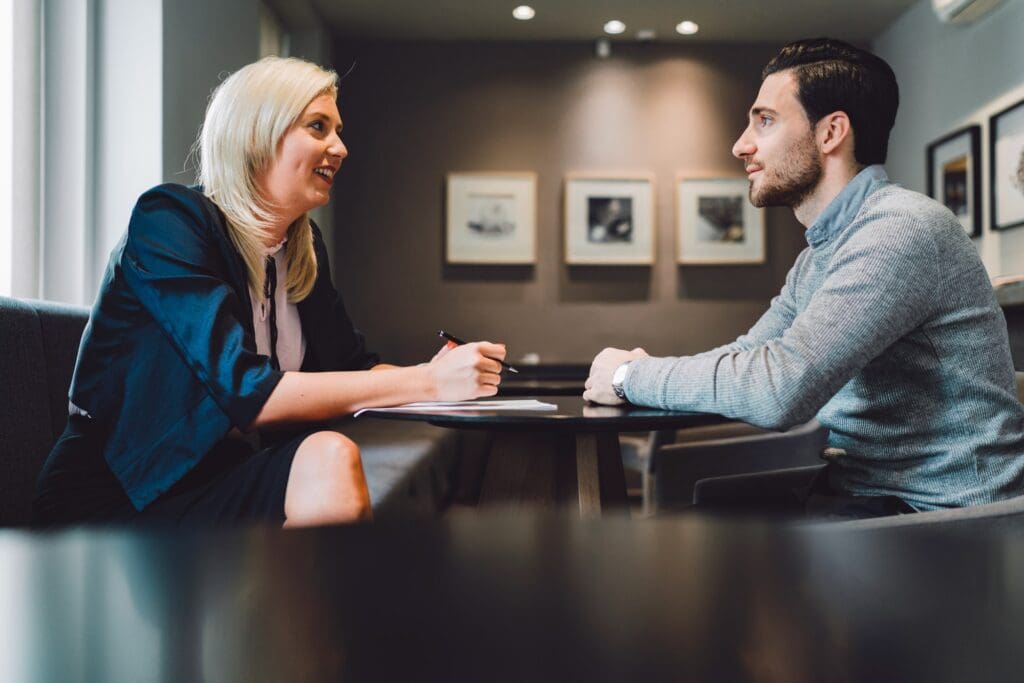 Business meeting one on one, blonde businesswoman, a lawyer, meeting with her client, young man