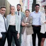 Team portrait multi-ethnic professionals smiling posing with confidence. Young and mature colleagues