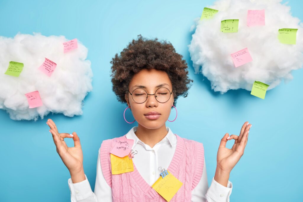 Calm relaxing female office worker in a stress relief room indoors keeps eyes closed New Your Times Wordle