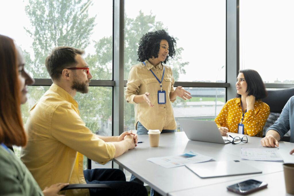 Woman senior sales manager business coach conducting business training to colleagues in meeting room