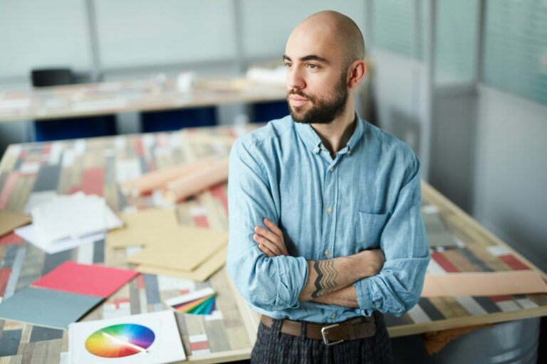 Serious purposeful man thinking about new design project