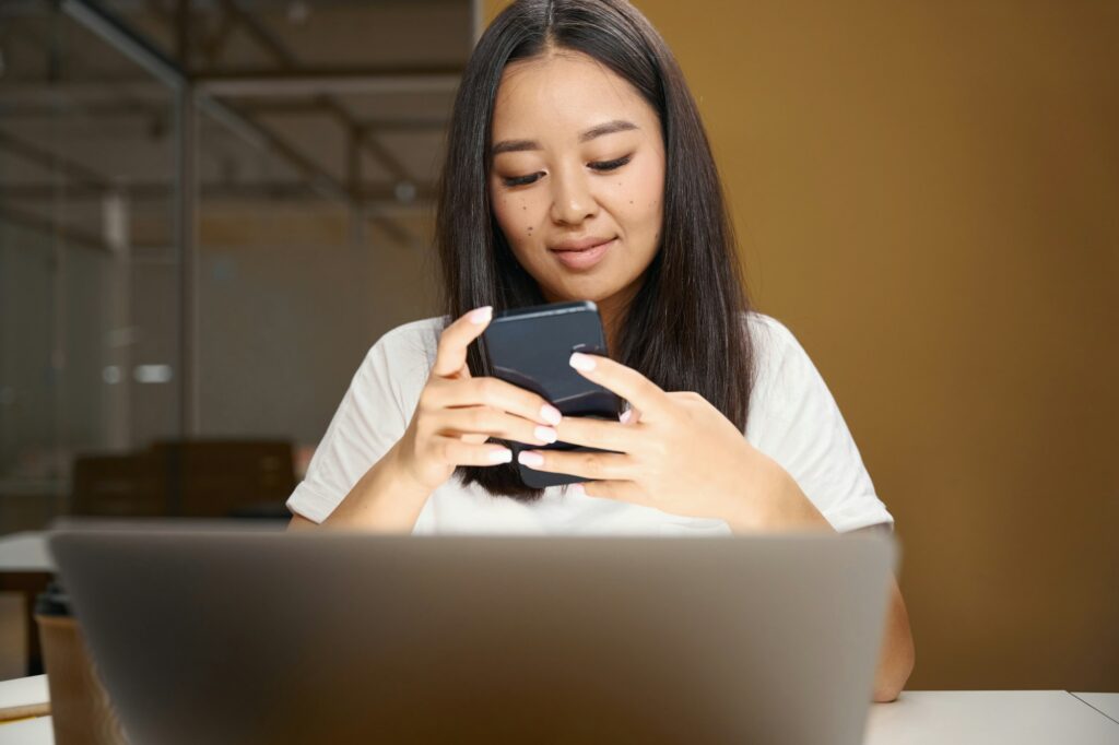 Entrepreneur with mobile phone is reading email in conference room