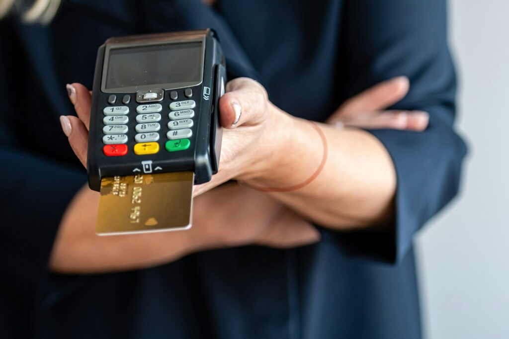 close-up of women hands hold terminal for payment by non-cash money
