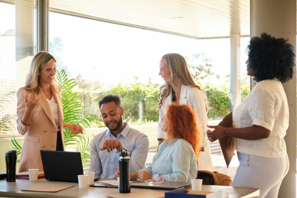 Group of people laughing and doing team building activities at work