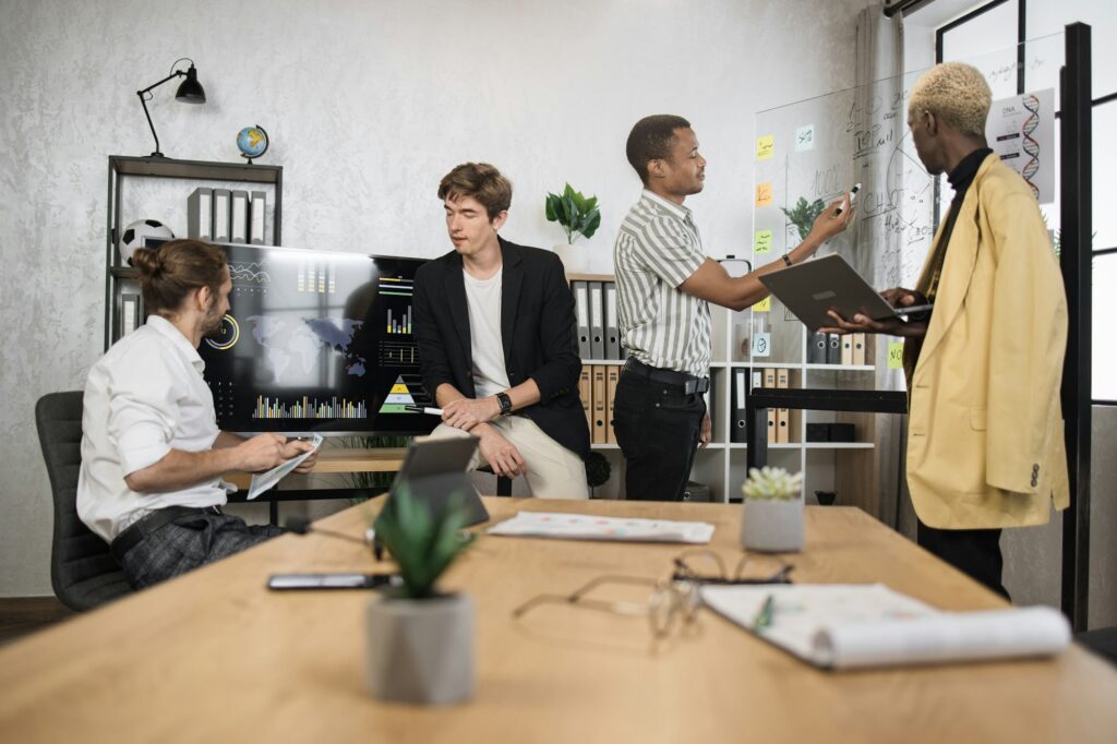 Multiracial male business people having briefing about financial situation at company.