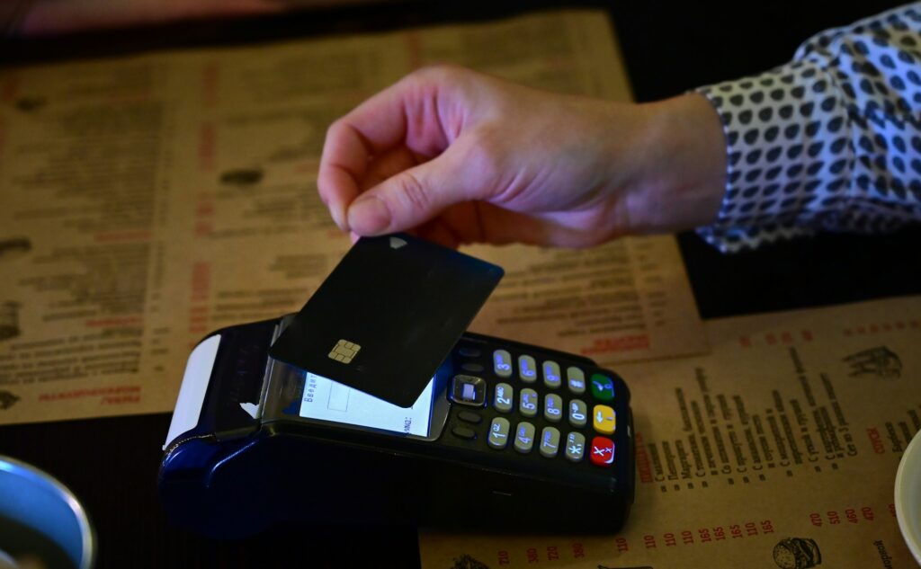 payment by card in the store using a contactless payment terminal with leave a tip screen