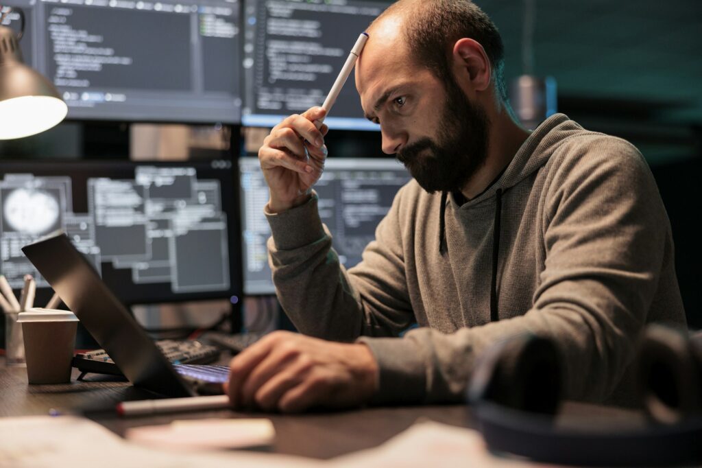 Coder brainstorming ideas to find source code for HR reps replaced by AI