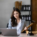 Lawyer woman working with a laptop computer in a law office. Legal and legal service concept.