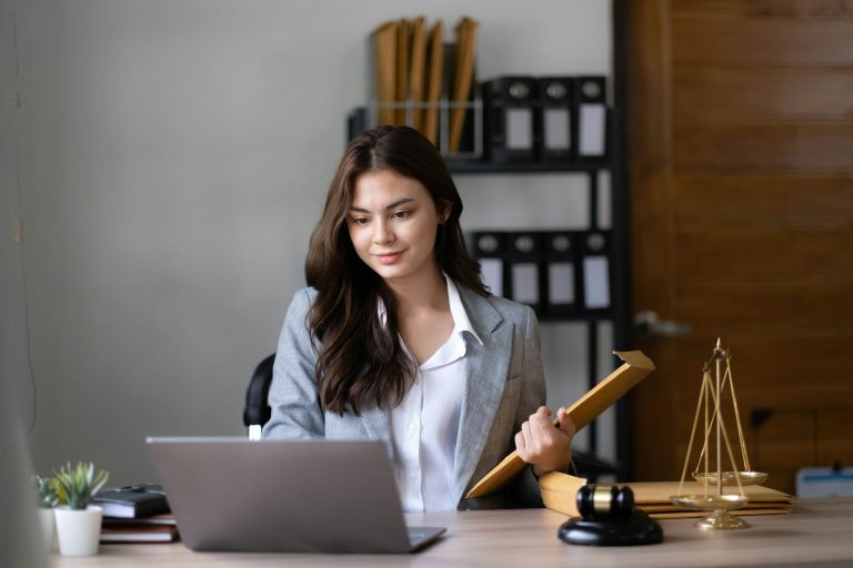 Lawyer woman working with a laptop computer in a law office. Legal and legal service concept.