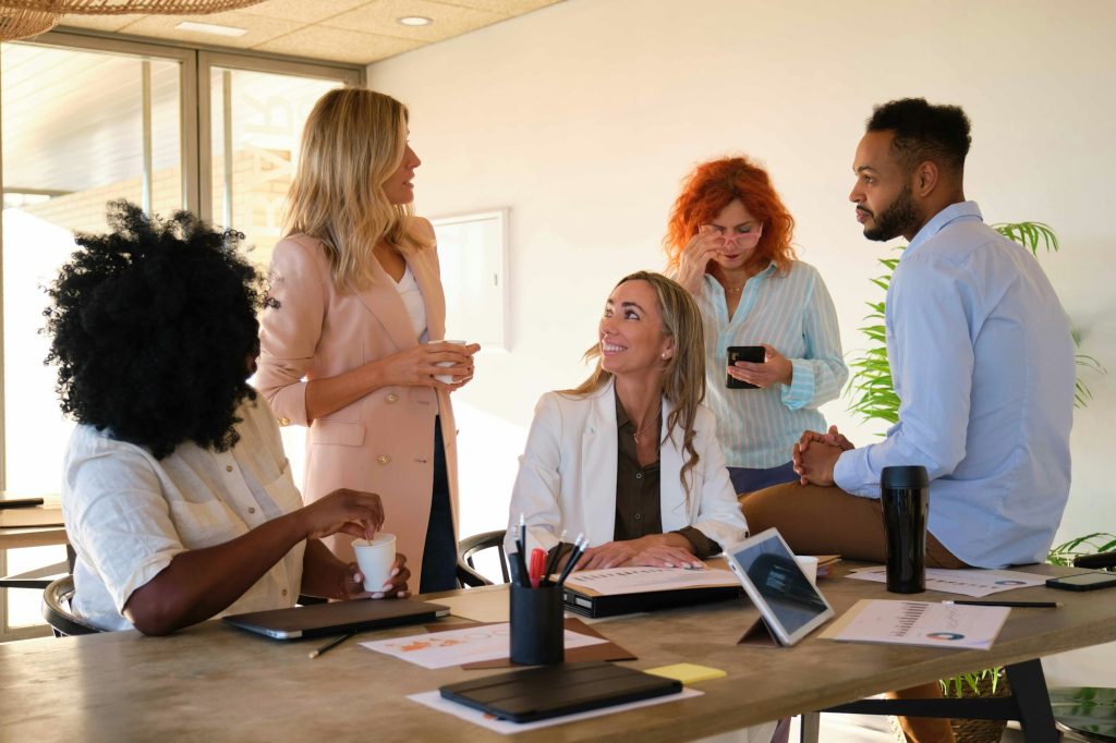 Business people with different work styles team building during coffee break at a coworking event.
