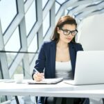 Businesswoman working at desk in modern office