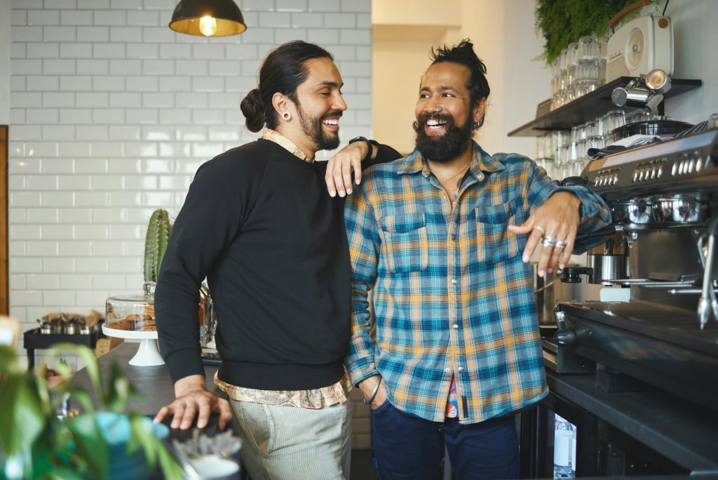 Coffee shop, partnership and small business with men and barista, types of leadership styles in hospitality