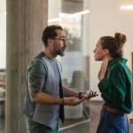 Colleagues arguing in office, problems at work.