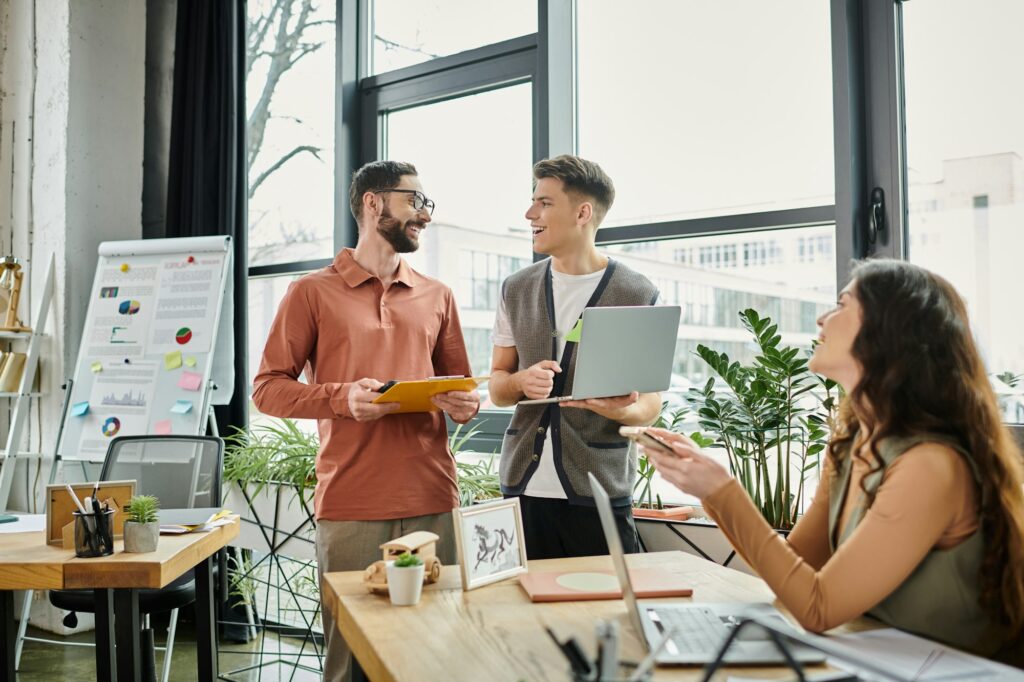 Colleagues Engaging in Conversation During Transition Meeting in Modern Office Space