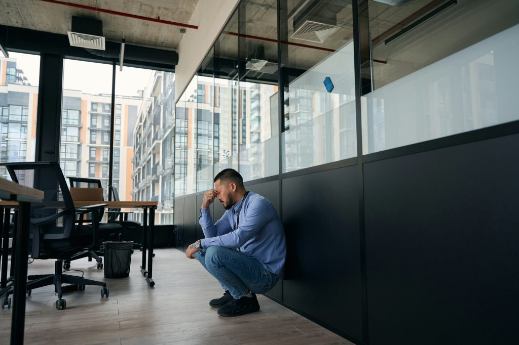 Exhausted office worker suffering from working conditions and job burnout