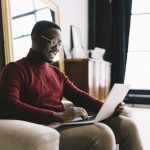 Happy man working on laptop