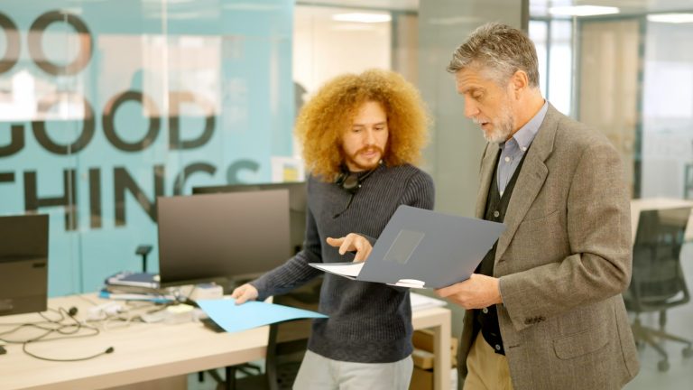 Manager and employee talking about informs in a coworking Constructive Criticism