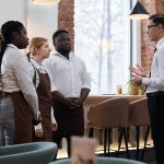 Restaurant Manager Talking To Waiting Staff