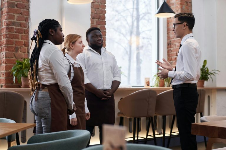 Restaurant Manager Talking To Waiting Staff
