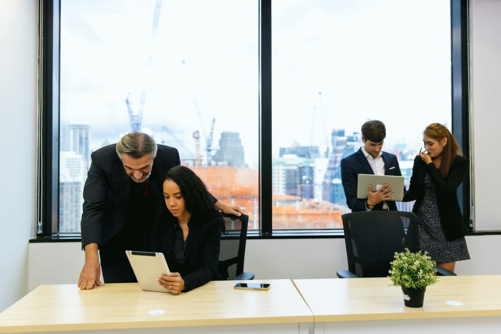 Businessman leader coaching interested business people to help define virtues of human flourishing