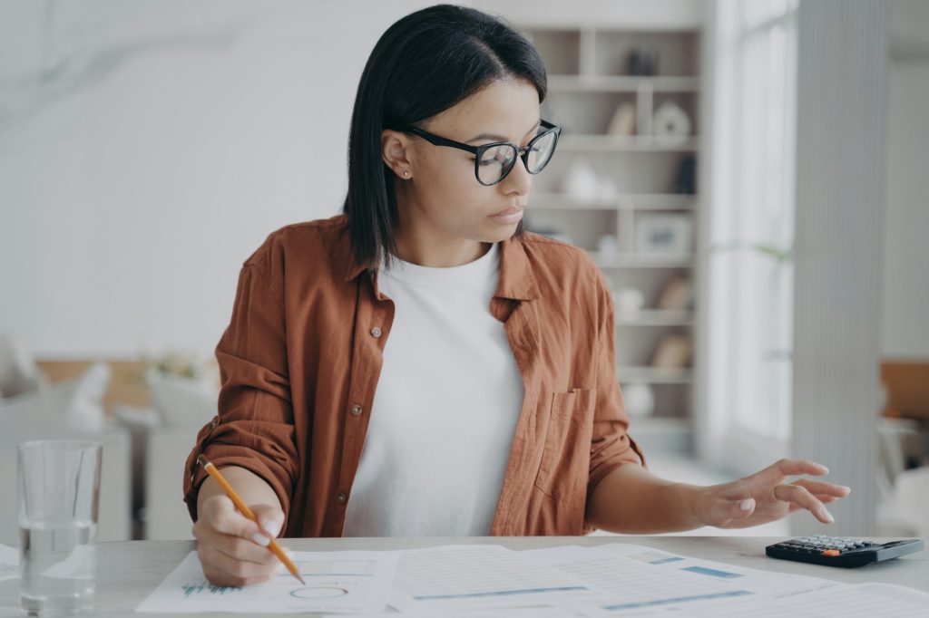 Businesswoman in glasses examines small business funding options