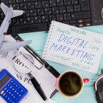 Digital marketing on notepad and various office supplies