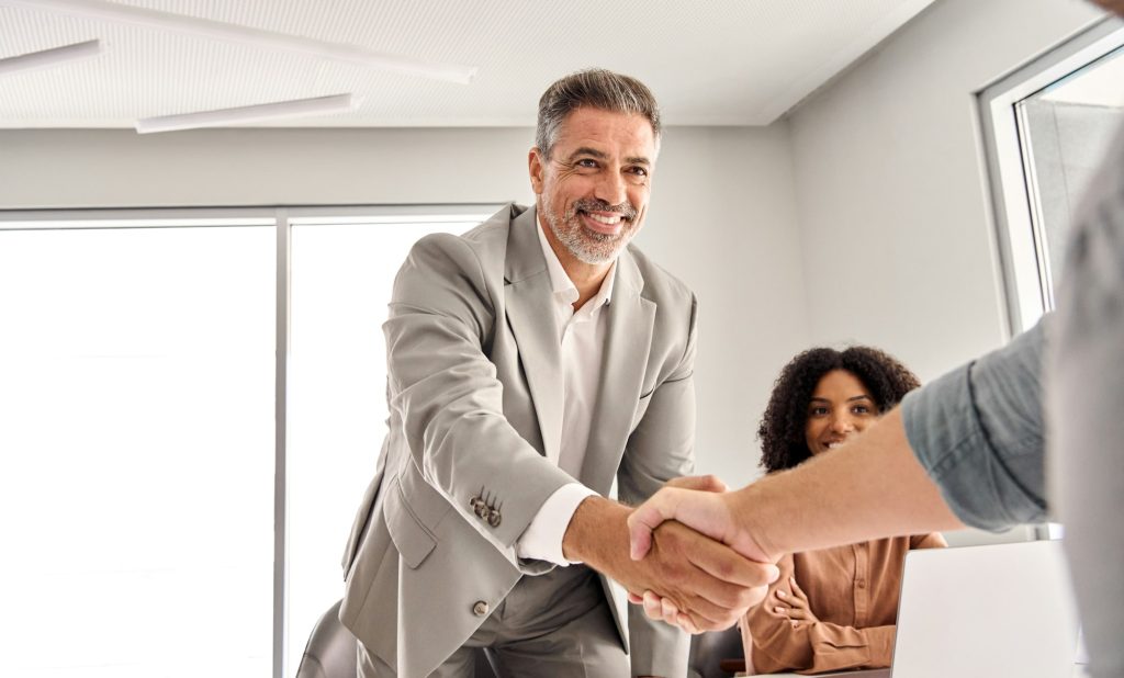 Businessman leader identifying an employee at board meeting.