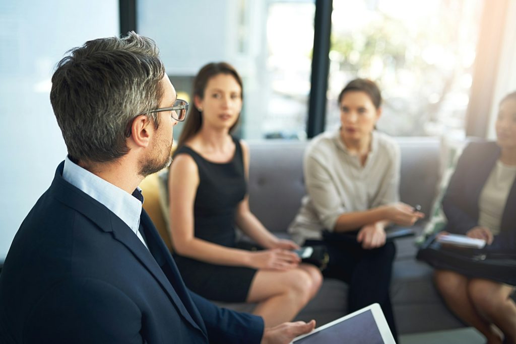 Shot of a group of businesspeople listening to their managers point of view during a meeting