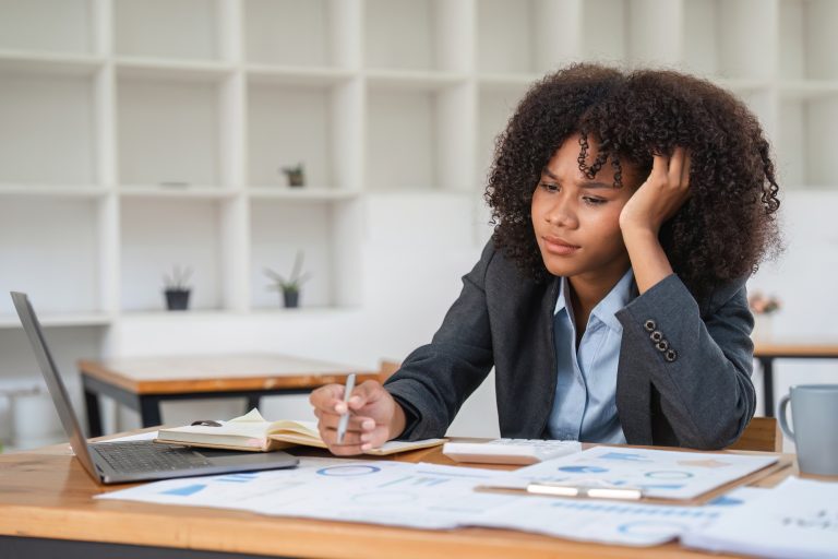 Young Female Accountant Feeling Bored and Disengaged at Work in Modern Office Setting