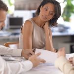 Totally unfocused. Shot of a businesswoman lost in thought while in a meeting.