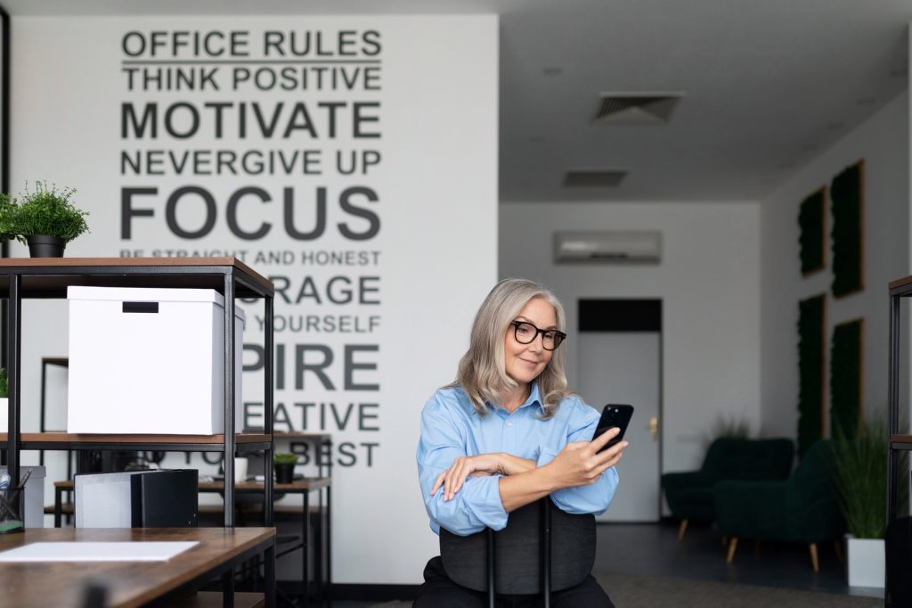 self-sufficient and self-confident businesswoman holding a phone in her hands in the office