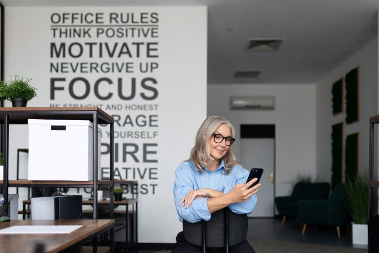 self-sufficient and self-confident businesswoman holding a phone in her hands in the office