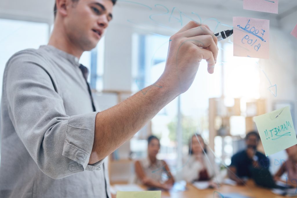 Presentation, leader and coach talking and writing ideas, marketing and advertising plan or strateg