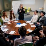 business conference or meeting at the hotel the manager tells colleagues the development plan