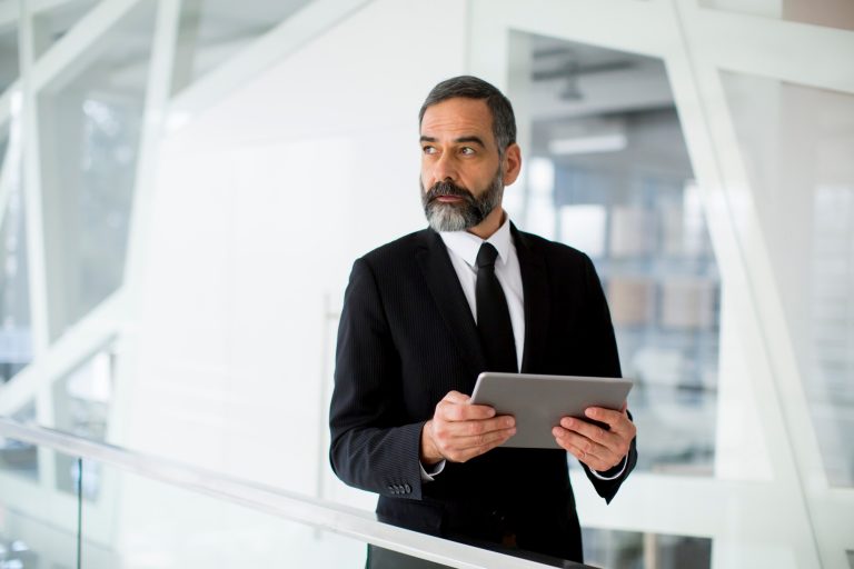 Middle age businessman with tablet in the office