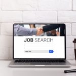 Pc on the desk with job search engine on display