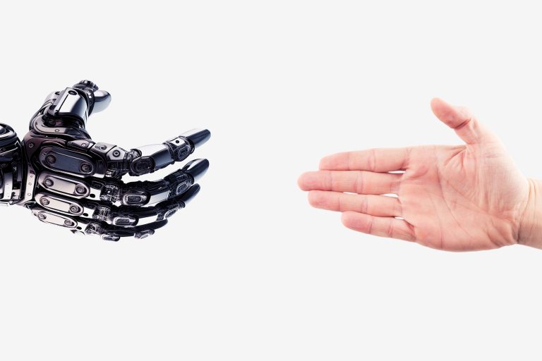 Robot hand reaches out to the human hand. Handshake of a cyborg and a man. Technology