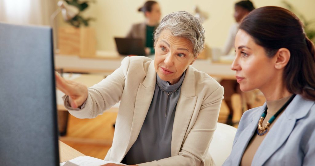 Business people, computer and manager in office for feedback, teamwork or employee development with