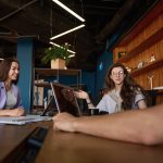 Friendly office team discussing workflow at a table in office