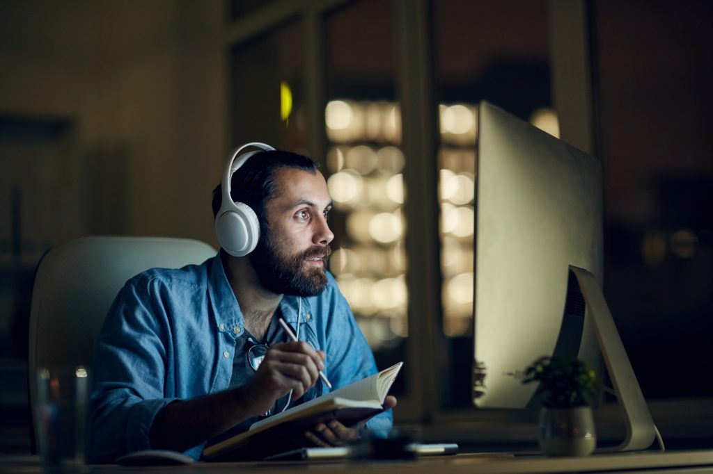 Man video conferencing with co-founder at night