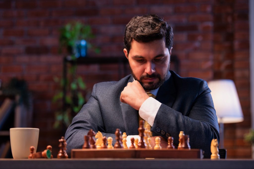 Indian executive playing chess in office, symbolizing business strategy and leadership planning