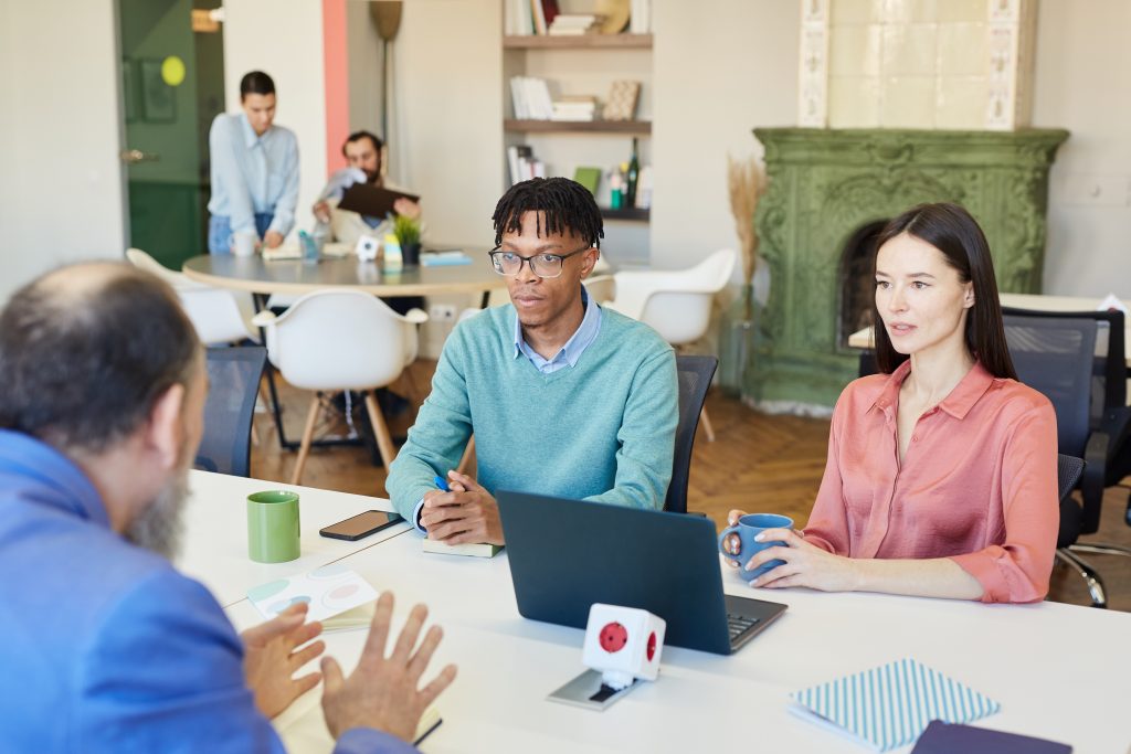Business meeting where colleagues discuss AI hiring bias in a modern workplace