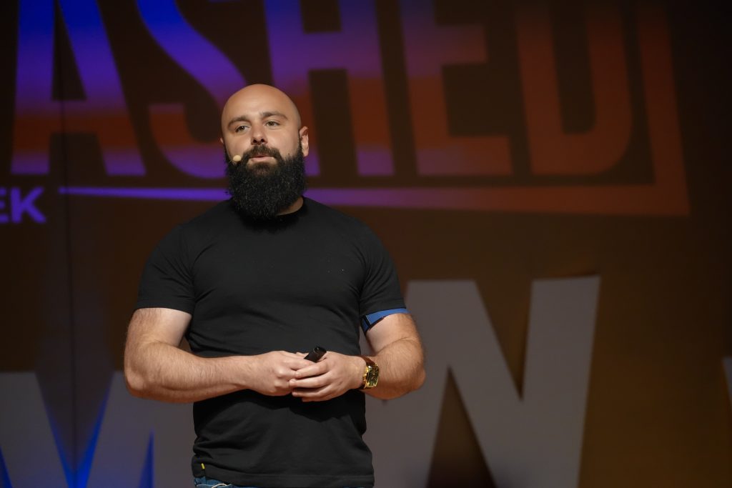 Ben Albert speaking on stage, where his networking tips for introverts include creating memorable experiences